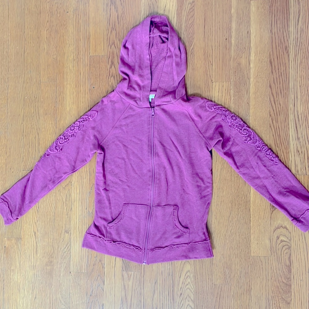 Zippered hoodie with distressed design and lace sleeve overlay. Never worn Sz 14